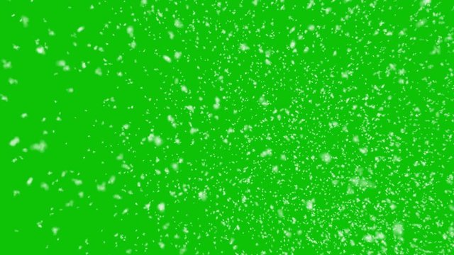 Isolated realistic snow falling with horizontal wind on a green screen background