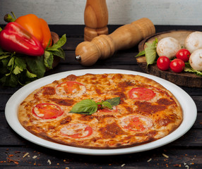 platter of margherita pizza garnished with basil