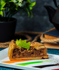 slice of apple pie garnished with cinnamon sprinkles and apple crown