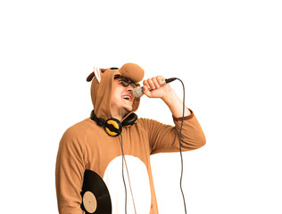 Man in cosplay costume of a cow singing karaoke isolated on white background. Guy in the funny...