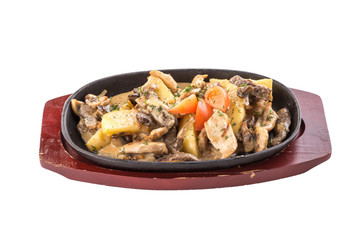 Potato stew with pork, mushrooms in sour cream sauce in cooking pan isolated on white background
