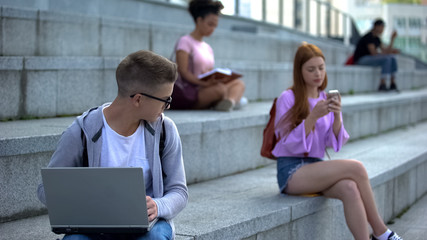 Timid male pupil laptop feeling shy looking pretty female classmate insecurities