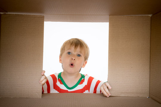 Surprised child unpack Christmas gift box