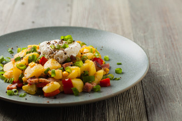 Traditional American hash with fried eggs. Front view.