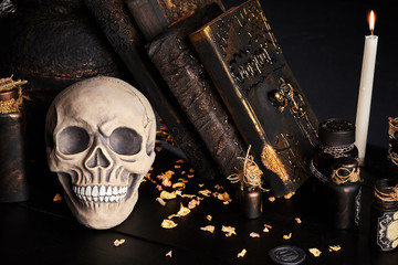 Realistic model of a human skull with teeth on a wooden dark table, black background. Medical...