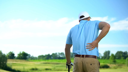 Male golf player feeling strong lower back pain after ball hitting, trauma - 297811140