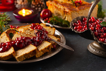 Delicious chicken and pork pate in Christmas decoration. Rustic style. Dark background, metal...
