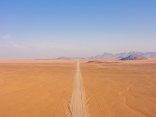 Fototapeta na wymiar Straight long desert road Namibia