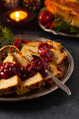 Delicious chicken and pork pate in Christmas decoration. Rustic style. Dark background, metal plates. Front view.