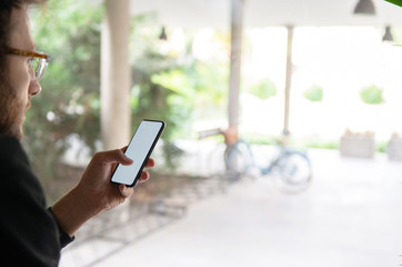 Male hand typing on mobile phone