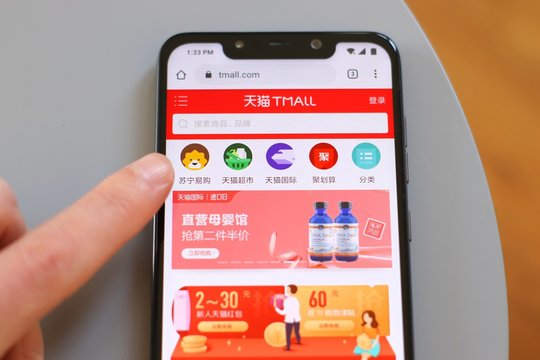 WARSAW, POLAND - OCTOBER 22, 2019: User visiting TMall Chinese shopping website on a Xiaomi F1 Pocophone smart phone.