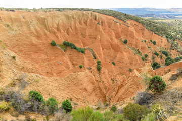 Valley eroded by rain and wind forming ravines in the red clay called Las Carcavas in Madrid © josevgluis