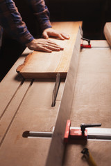 Carpentry workshop background with male hands and tools