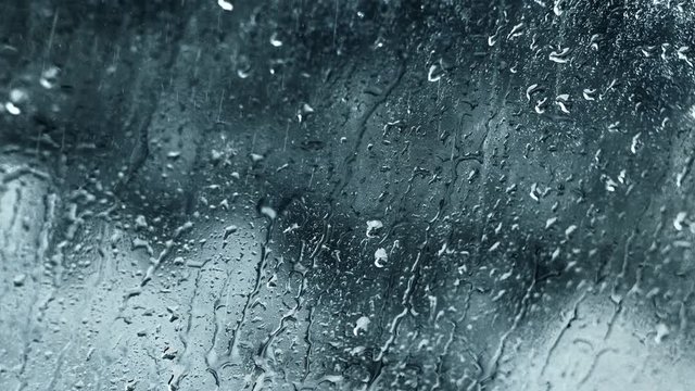 Rain drops motion. Fall season. Water splash on gray glass background for screen filter.