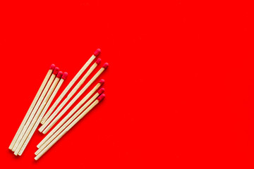 Symbol of danger with matches on red background top view copyspace