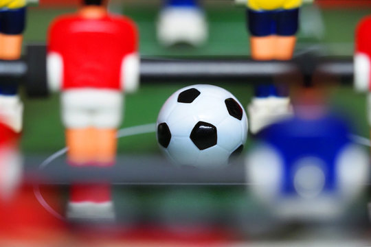 Table soccer, foosball. Soccer ball macro. Sport team football players. Leisure and entertainment