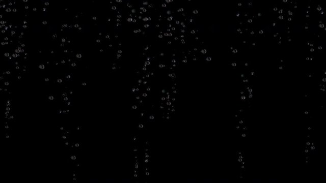 Soda pop bubbles rising up in a dark night water liquid texture background