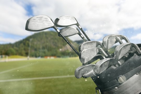 Different golf clubs on  background.