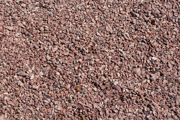 Background of small red pebbles. Walking path cover texture. Fine gravel
