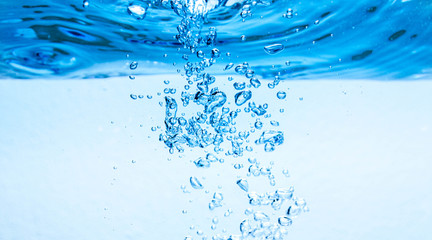 Underwater, under the blue sea, under the water there are bubbles