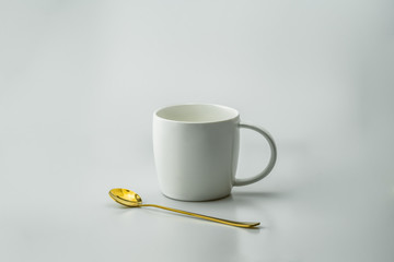 luxury white cup and gold spoon with white background