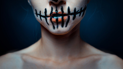 Girl with Halloween sugar skull make up, close up. Horror spooky skeleton visage concept