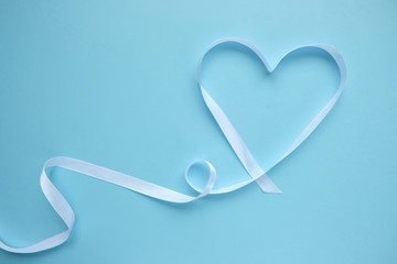 white ribbon in the shape of a heart