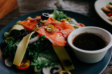 Fototapeta na wymiar Close up Salmon Salad on black plate.