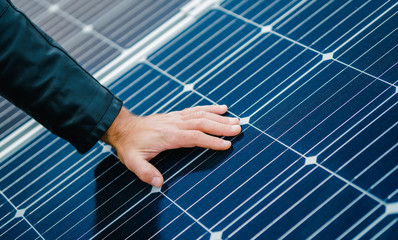 loseup view, man hand lay on solar panels