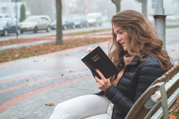Fototapeta premium Women in outdoors reading Bible. Concept for faith, spirituality and religion