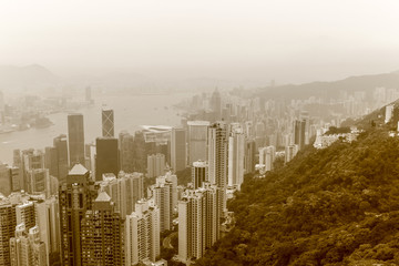 Fototapeta premium View on Skyscrapers with Victoria Bay, Transportation Ships, Harbour and Kowloon taken from Hongkong Island Peak. Hong Kong, China