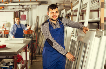 Obraz premium Production workers in coverall with different finished PVC pro