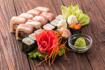 Sushi set on the wooden table. Closeup of delicious japanese food with sushi roll.