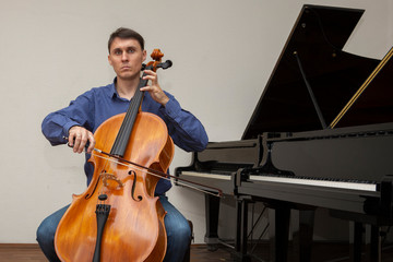 Musicians of the symphony orchestra. Cellist at a rehearsal.