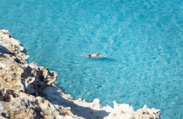 Men swiming in the shore of Torre dell'Orso