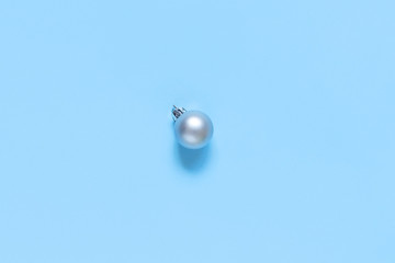 Silver Christmas bauble on a light blue background