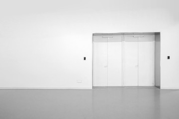 White walls and grey cement floors in the interior space