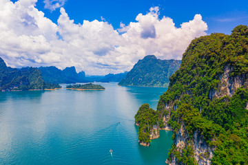 Fototapeta na wymiar Beautiful mountain and blue sky with cloud in Khao Sok National park locate in Ratchaprapha dam in Surat Thani province, Thailand.