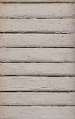 Texture of cracked wooden panels covered with old peeled white paint