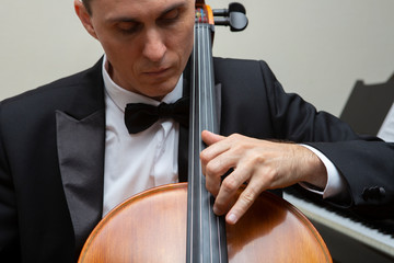 Musicians of the symphony orchestra. Cellist in concert costume. © biggur