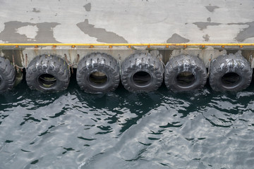 fender tyres on quay at small harbor on Barents sea,  Batsfjord, Norway