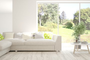 Stylish room in white color with sofa and summer landscape in window. Scandinavian interior design. 3D illustration