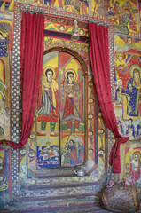 Paintings inside the church. Christian murals on the walls. Ceremonial drum covered with cow skin. Ethiopia, Islands of Lake Tana, near Bahir Dar