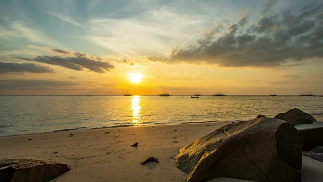 Time lapse of Dramatic Sunset with big rock as foreground at bukit berahu beach in belitung island indonesia