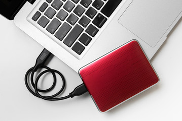 External Hard disk connect to laptop, External Harddisk and laptop computer, White background, Top view workspace
