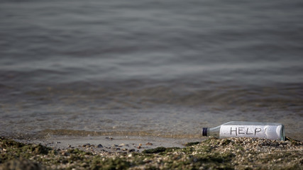 Help word hidden in bottle lying near sea, request for salvation, secret message