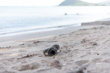 garbage shoes  castaway on the beach makes global warming