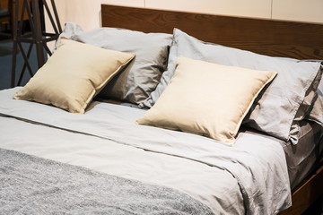 Bed with brown sheets and pillows