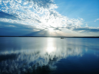 Naklejka na ściany i meble dawn on the lake. sunlight over the water