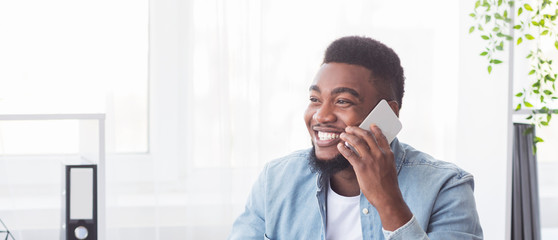 Happy office worker received good news on phone